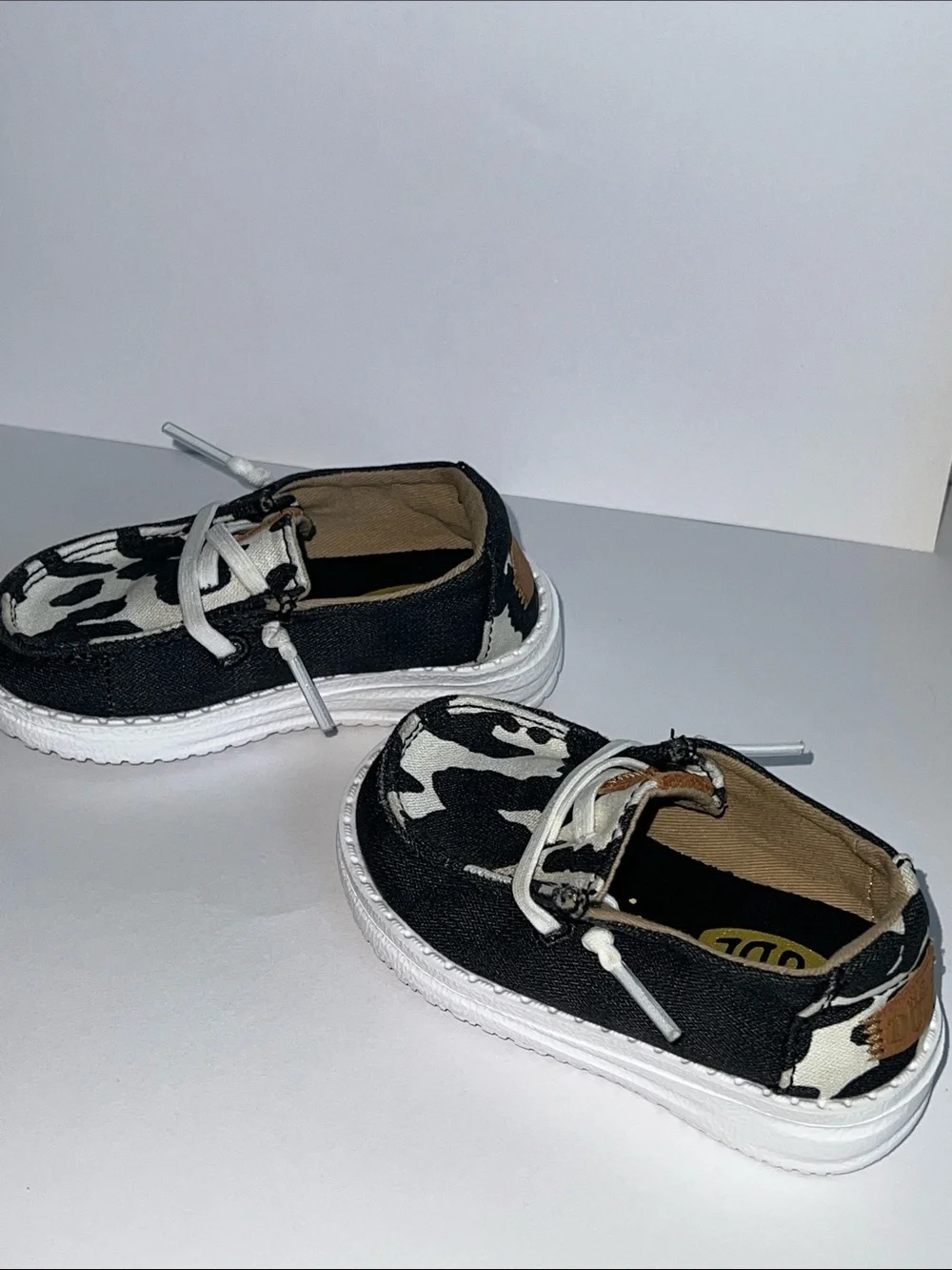 Hey Dude Wendy Black and White Cow Print Slip-On Loafers